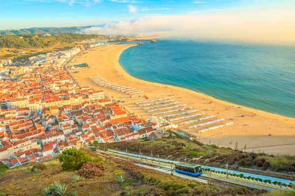 View of Nazare cabins train Funicular. Nazare in Portugal is the most popular seaside resorts in Atlantic coast. Nazare Skyline and beach waterfront from Nazare Sitio.