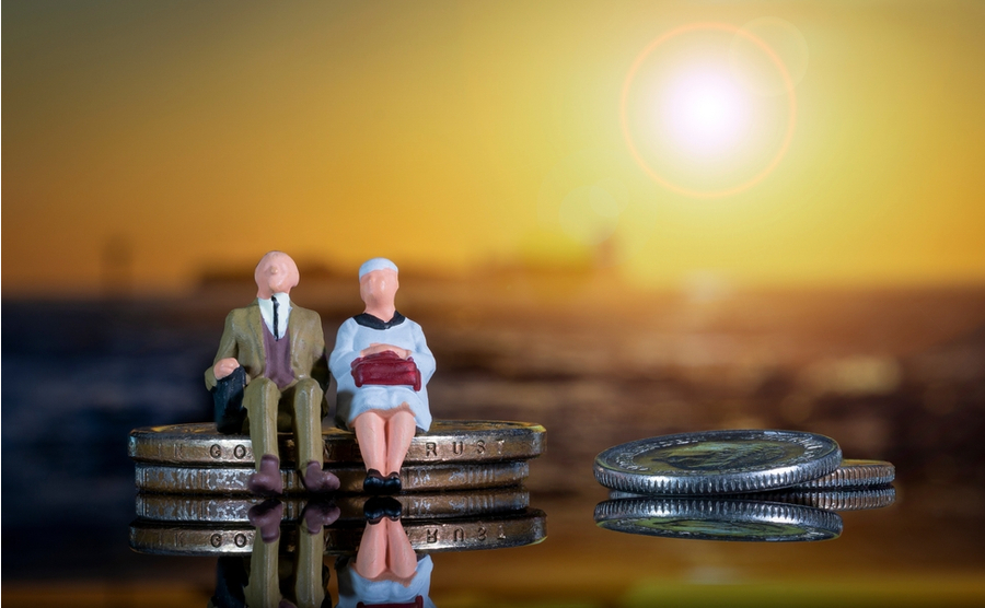elderly couple sat on money, figures, concept for pension