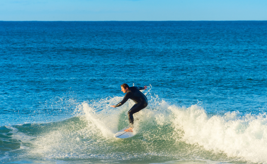Surfer ride a wave on surfboard in Peniche