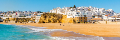 Wide sandy beach in white city of Albufeira, Algarve, Portugal